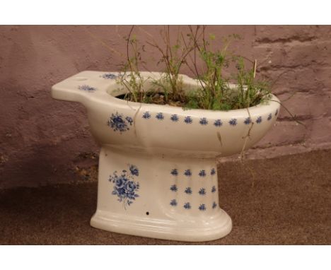Victorian style blue and white decorated toilet basin planted with shrubs