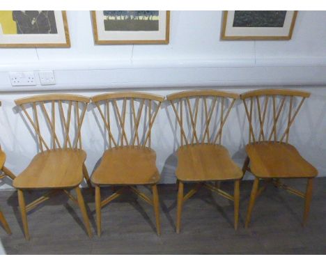 Two sets of four Ercol cross back dining chairs, in elm, each set with different shaped seat.All seem structurally sound but 