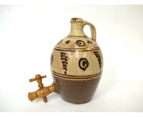 A Winchcombe Pottery flagon with painted tenmuko motifs over slip. Turned wooden tap. Impressed pottery seal only. 29cm high.