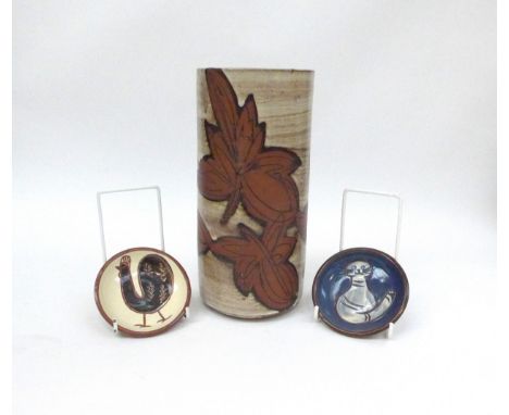 A large Briglin pottery cylindrical vase with leaf detail 26cm high, together with two Briglin pin dishes with chicken and ca