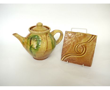 CLIVE BOWEN (b.1943) A studio pottery teapot in pale ochre glaze and painted green detail, 18cm high, together with a tile wi