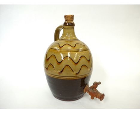 A Winchcombe Pottery flagon probably by Ray Finch with ochre glaze and painted wave line detail. Impressed pottery seal only.