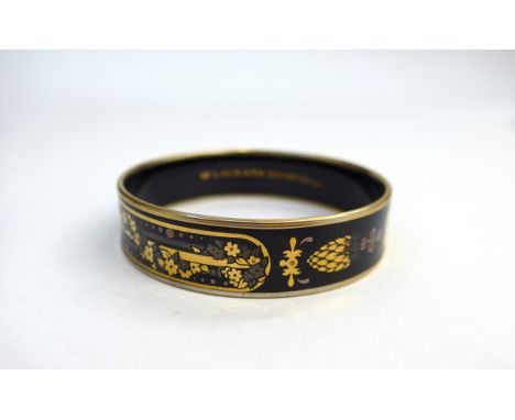 A Laurana Italian enamel bangle in black ground with bronze, silver and gold coloured design, circa 1960's