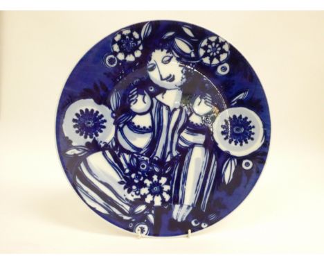 A Rosenthal porcelain Bjorn Wiinblad Studio Linie wall plate in blue and white with figural design.  32.7cm diameter