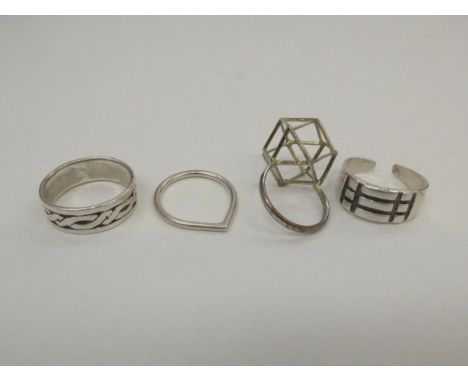 A Mid Century silver stylised buckle ring, makers mark M.W, a silver Celtic band ring, W.M teardrop ring and a 1960's 3D Poly