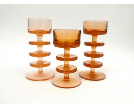 Three Wedgwood Sheringham candlesticks by Ronald Stennett-Willson in amber/topaz, three ring and two ring. Tallest 15.4cm