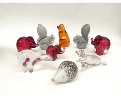 A collection of nine Wedgwood animal paperweights in coloured and clear glass including Elephants, Squirrels, Dog, Hedgehog, 