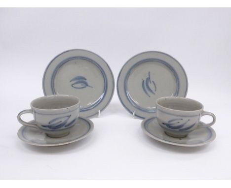 Two Crowan Pottery trios by Harry and May Davis with painted foliate detail in blue.  Impressed pottery seals. Plate diameter