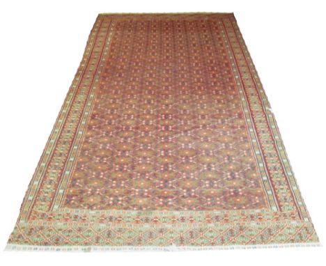 AFGHAN SOUMAKH, 400cm x 205cm, all over gul design on ruby field within multiple bands and border.