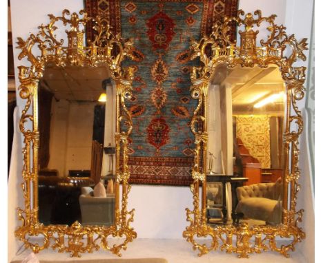 WALL MIRRORS, a pair, carved giltwood of Chinese chippendale influence with shaped bevelled plates, 204cm H x 101cm. (2)