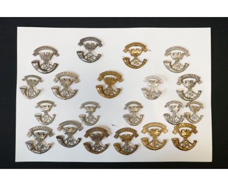 A Collection Of Twenty The Somerset Light Infantry Regimental Cap Badges To Include Brass And White Metal Examples. 