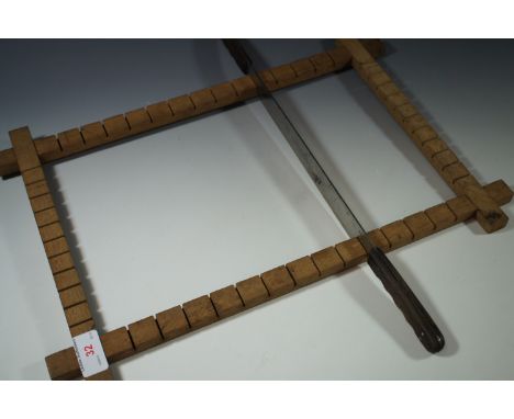 A vintage confectionary- or toffee-cutting knife and wooden frame