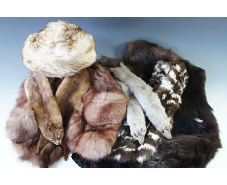 A vintage Harrods dress box containing a collection of vintage furs, including tippets, stoles, a muff and a hat, predominant