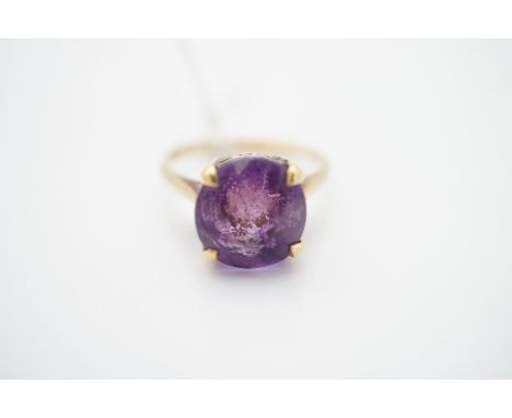 A vintage amethyst cocktail ring, the circular-cut amethyst of approximately 3.3ct, crown-set on a high-carat yellow-metal re