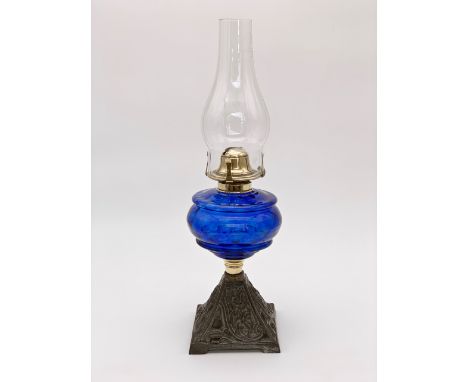 A Victorian oil lamp having a blue glass reservoir