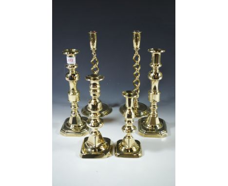 A pair of Victorian brass candlestick, a pair of double-helical brass candlesticks and two others, tallest 30 cm 