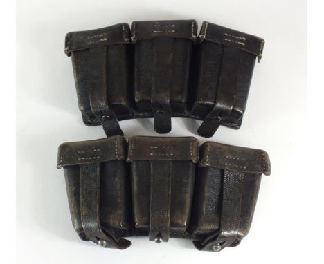 Two German Second World War standard rifle ammunition pouches constructed of black pebbled leather, one dated 1940