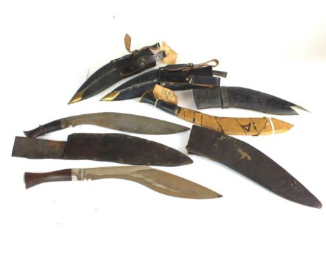 A group of three kukri knives in leather sheaths, early-mid 20th century, one of which still bears the original Army G1602 la
