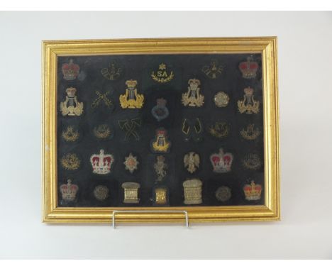 A framed selection of thirty-three army cloth "bullion" badges