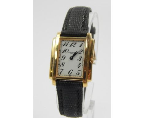 A 18ct gold Patek Philippe ladies wristwatch, with white enamel dial and gold surround, on black leather strap.