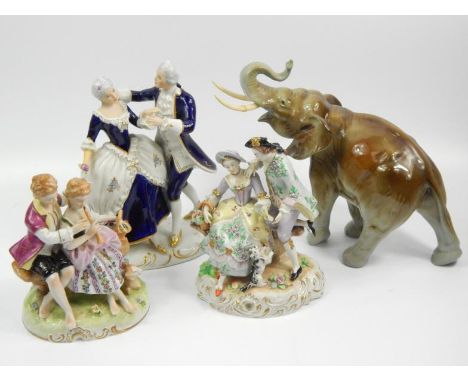 A 20thC Royal Dux figure of an elephant, with trunk raised, 22cm high, another Dux figure of a courting couple and two furthe