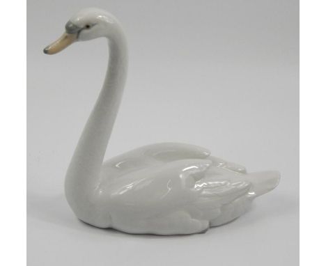 A Lladro porcelain figure of a swan, 22cm  high.