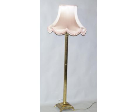 A 20thC brass framed lamp standard, the cylindrical reeded body raised on a square stepped base, terminating in hairy paw fee