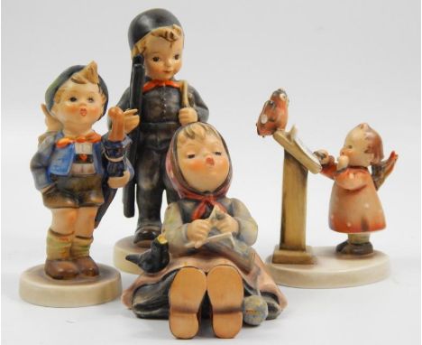 Four Goebel ceramic figures, the Bird Duet, girl seated with a bird, boy with umbrella and a young boy with a small ladder, p