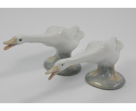 Two similar Lladro porcelain figures, each in the form of a goose, on an oval base, 16cm wide.