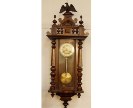 An early 20thC walnut cased Vienna wall clock, the 14cm diameter dial revealing an 8 day movement contained in a three part g