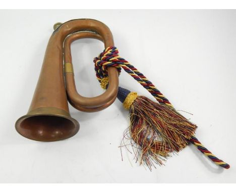 A Regimental copper and brass bugle, with plated mouthpiece and multi-coloured braid, 27cm long.