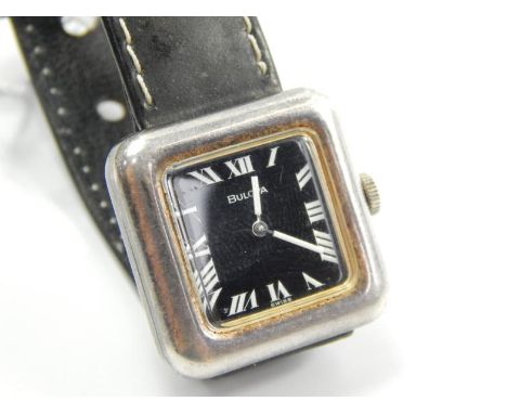 A silver Bulova ladies wristwatch, with black dial, and black leather strap.