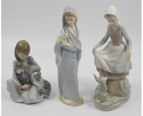 Three Lladro figures, to include a lady with a basket of flowers, a child with dog and kitten on knee and a lady with rabbit,