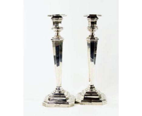 A pair of Edwardian silver candlesticks, with loaded bases, registration mark, Sheffield Assay 1909, maker JD & S, 30cm high.