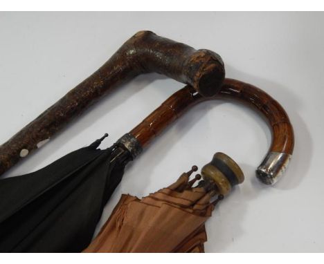 A silver mounted umbrella, a small umbrella and a walking stick, (3).