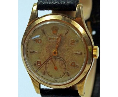 A 1950's 9ct gold Rolex gentlemans wristwatch, with matt cream dial, Arabic numerals and triangular markers with minute track