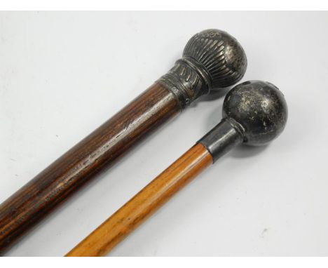 A late Victorian/early 20thC ebonised walking cane, with white metal mount and a Regimental swagger stick for The Shrewsbury 