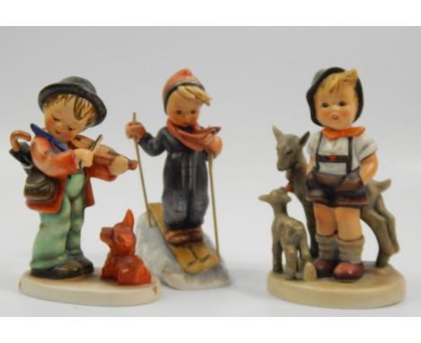 Three Goebel ceramic figures, Puppy Love, Goat Herder and a young boy skiing, each after Hummel.