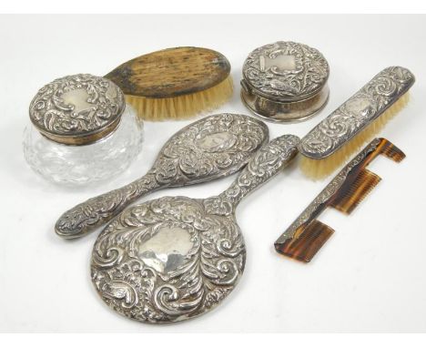 A matched Elizabeth II silver part dressing table set, to include hairbrush, comb, hand mirror 22cm high, lidded jar, pin dis