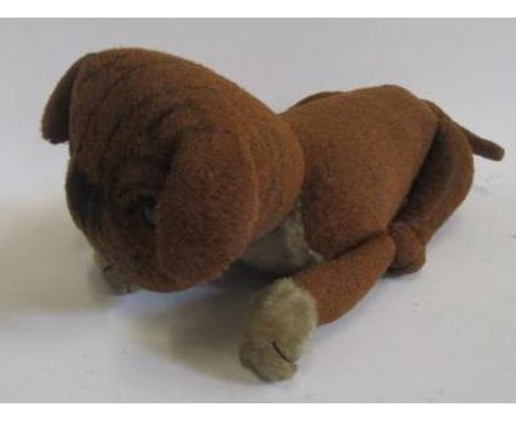 A Steiff pug dog, c.1910, with black button eyes, later sewn nose, covered in brown and cream plush, swivel joints, 13 1/2" l
