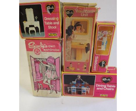 Six boxed Sindy accessories comprising bed and bed clothes, dining table and chairs, sideboard, wash basin unit, dressing tab