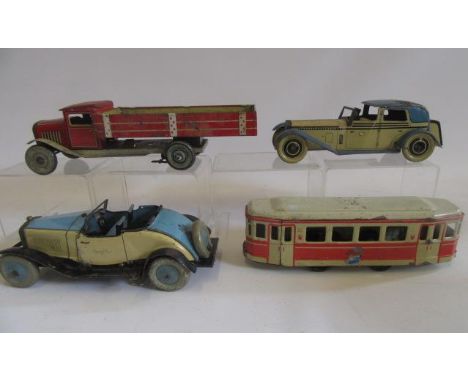 Two tinplate cars, a tipper lorry and a railway carriage, mainly clockwork by Wells, Tipp &amp; Co and Chad Valley, P-G (Est.