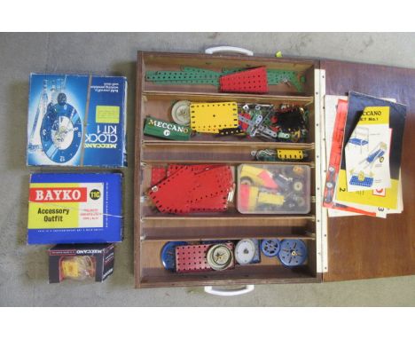 A Meccano Clock Kit 1, a Meccano reversible motor, a Bayko 11c Accessory Outfit, all boxed, and a quantity of Meccano parts i