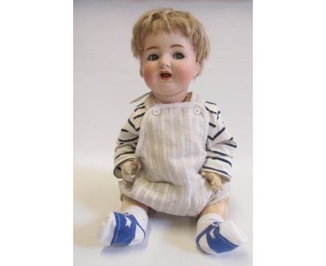 A Kammer &amp; Reinhardt bisque head character doll with blue glass flirty eyes, open mouth and teeth, blonde mohair wig, com