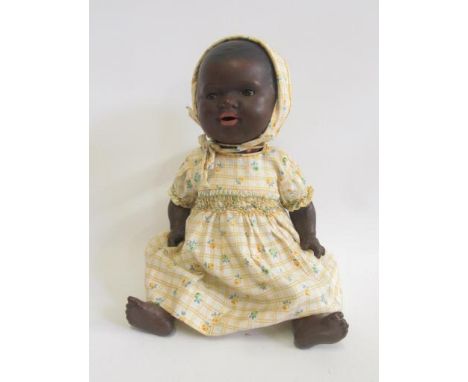 An Armand Marseille bisque head black baby doll with brown glass sleeping eyes, open mouth, pierced ears, moulded hair, compo