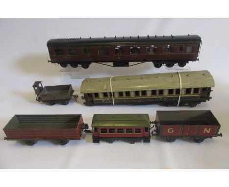 A Gauge 1 rolling stock L.M.S. dining car, six wheel bogies, finished in lined L.M.S. red, some damage to one side, interior 