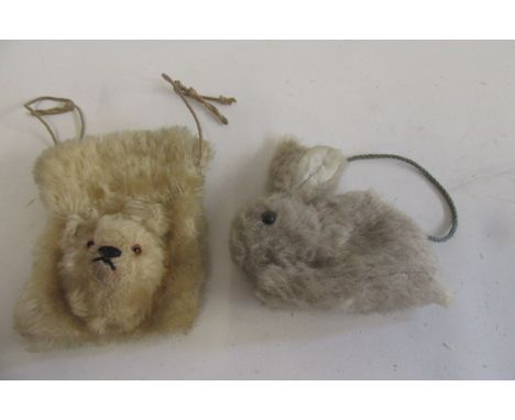 A teddy purse covered in long beige plush with black/amber eyes, 5" high, and a rabbit purse in fawn plush with black button 