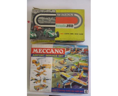 A Wrenn Formula 152 Motor Racing Set with six racers, track, controls and manual, box AF, and a Meccano Airport Service Set 4