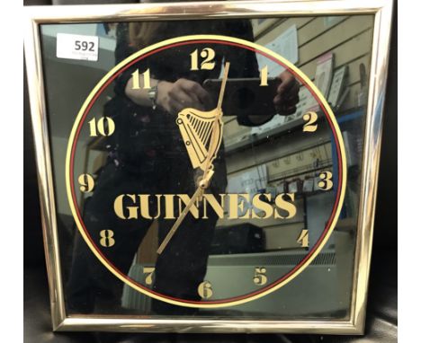 A Guinness Wall Clock modern, battery operated (untested) and a pair of Vintage enamelled advertising Guinness novelty cuffli