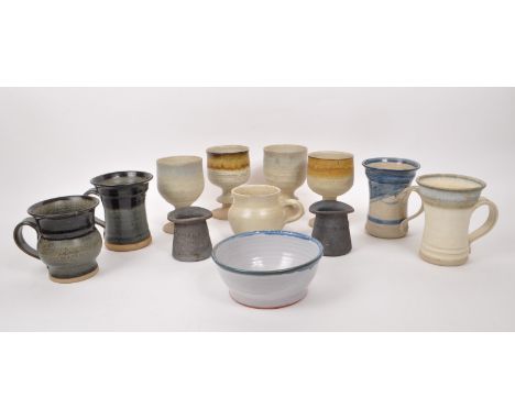 A collection of 20th-century studio pottery stoneware pieces, comprising of ceramic mugs, goblets, a bowl, and two earthenwar